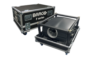 Barco F series projector in a metal frame beside a black wheeled flight case labeled BARCO F series with reinforced metal edges and handles, both on wheels, set against a white background.